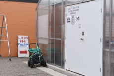 A sign that will direct people to the FFA plant sale beginning today (May 7) leans against the exterior of Lincoln High School. The sale will take place in the greenhouse at right located behind the tennis courts off of Prairie Street.